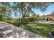 Stunning exterior view of the home with a circular driveway and lush landscaping at 4225 Ulman Ave, North Port, FL 34286