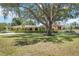 Well-manicured lawn and mature trees frame this elegant home, creating a serene setting at 4225 Ulman Ave, North Port, FL 34286