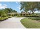 Beautiful single-story home with lush landscaping and a curved driveway on a sunny day at 4225 Ulman Ave, North Port, FL 34286