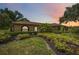 Charming one-story home with a landscaped yard, manicured bushes, and beautiful windows at 4225 Ulman Ave, North Port, FL 34286