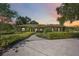 Beautiful exterior elevation of a landscaped home with a circular driveway and manicured greenery at 4225 Ulman Ave, North Port, FL 34286