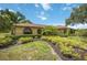 Charming one-story home with a landscaped yard, manicured bushes, and beautiful windows at 4225 Ulman Ave, North Port, FL 34286