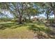 Lush landscaping and mature trees surround the home's exterior at 4225 Ulman Ave, North Port, FL 34286
