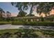 Charming home with a well-manicured front yard and hedge, complemented by lush trees at 4225 Ulman Ave, North Port, FL 34286