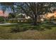 Expansive property featuring a well-manicured lawn and mature tree offering ample shade at 4225 Ulman Ave, North Port, FL 34286