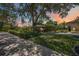 Stunning exterior view of the home with a circular driveway and lush landscaping at 4225 Ulman Ave, North Port, FL 34286