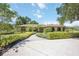 Charming exterior shot showcases the lush landscaping and inviting facade of the home at 4225 Ulman Ave, North Port, FL 34286
