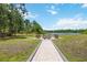 Outdoor entertainment area featuring a custom fire pit and seating overlooking the serene lake at 4225 Ulman Ave, North Port, FL 34286