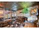 Spacious game room with unique decor, including a pinball machine and decorative tin ceiling at 4225 Ulman Ave, North Port, FL 34286