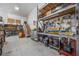 This spacious garage provides ample storage with shelving, pegboards, and a staircase to an upper level at 4225 Ulman Ave, North Port, FL 34286