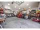 This garage features an abundance of storage, work areas, and bright lighting throughout at 4225 Ulman Ave, North Port, FL 34286