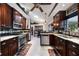 Spacious kitchen with dark wood cabinets, granite countertops, and stainless steel appliances at 4225 Ulman Ave, North Port, FL 34286