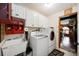 Well-organized laundry room with white cabinets, modern appliances, and a utility sink at 4225 Ulman Ave, North Port, FL 34286