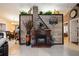Cozy living room with a brick fireplace, wood accents, plants, and decorative wall art at 4225 Ulman Ave, North Port, FL 34286