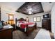 Main bedroom showcasing a bed with red and white linens, decorative ceiling and matching night stands at 4225 Ulman Ave, North Port, FL 34286