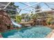 Enclosed pool area featuring a rock waterfall and slide for a resort-like feel at 4225 Ulman Ave, North Port, FL 34286