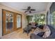 Cozy sunroom featuring tile flooring, a ceiling fan, and comfortable seating at 4225 Ulman Ave, North Port, FL 34286