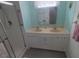 Bathroom featuring vanity with dual sinks and glass-enclosed shower at 5119 Glen Echo Ave, Sarasota, FL 34234