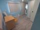 Bedroom with bright blue walls, desk, and closet offers a calm and functional living space at 5119 Glen Echo Ave, Sarasota, FL 34234