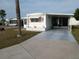 Attractive mobile home features a carport, tidy landscaping, and a welcoming exterior, offering comfortable living at 5119 Glen Echo Ave, Sarasota, FL 34234