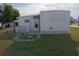 Mobile home with a private entrance and functional outdoor space, perfect for storage or additional living area at 5119 Glen Echo Ave, Sarasota, FL 34234