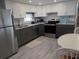 Well-lit kitchen features stainless steel appliances, two tone cabinets, and a breakfast table for easy dining at 5119 Glen Echo Ave, Sarasota, FL 34234
