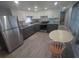 Bright kitchen boasts white cabinets, granite countertops, and stainless steel appliances for a modern look at 5119 Glen Echo Ave, Sarasota, FL 34234
