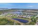 An aerial view of a waterfront community with lush landscaping, serene lakes, and picturesque homes at 523 Wildlife Gln, Bradenton, FL 34209