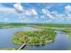 Scenic aerial view of Robinson Preserve with paved walking paths, a waterfront, and palm trees at 523 Wildlife Gln, Bradenton, FL 34209