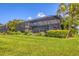 View of the backyard with well manicured lawn and landscaping and a screen enclosed pool at 523 Wildlife Gln, Bradenton, FL 34209