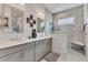 Modern bathroom boasts double vanity, granite counters, and luxurious walk-in shower with marble tile at 523 Wildlife Gln, Bradenton, FL 34209