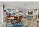 Bright, open-concept dining area featuring a stylish table, modern lighting, and seamless flow into the living room and kitchen at 523 Wildlife Gln, Bradenton, FL 34209