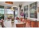 Bright dining room features modern light fixture, sleek table, and sliding glass doors to screened lanai at 523 Wildlife Gln, Bradenton, FL 34209