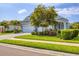 Charming single-Gathering home with a lush, green lawn and a well-manicured garden under the mature tree at 523 Wildlife Gln, Bradenton, FL 34209