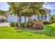 Lovely single-Gathering home featuring lush landscaping, stone accents, a two-car garage, and a front lawn at 523 Wildlife Gln, Bradenton, FL 34209