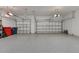 Spacious three-car garage with epoxy flooring and ample room for vehicles and storage at 523 Wildlife Gln, Bradenton, FL 34209