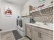 Modern laundry room with front loading washer and dryer, ample counter space, and mosaic tile backsplash at 523 Wildlife Gln, Bradenton, FL 34209