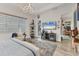 Bright main bedroom with modern furnishings, wood-look tile floors, and serene seating area at 523 Wildlife Gln, Bradenton, FL 34209