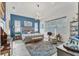 Stylish main bedroom with modern lighting, wood-look tile flooring, and serene blue accent wall at 523 Wildlife Gln, Bradenton, FL 34209