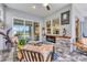 Inviting covered patio with a stone fireplace, comfortable seating, and access to the pool area at 523 Wildlife Gln, Bradenton, FL 34209