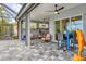 Spacious, screened-in patio features an outdoor dining area and a separate seating area for relaxation at 523 Wildlife Gln, Bradenton, FL 34209