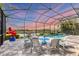 Screened-in pool area with comfortable seating and tranquil waterfront views for relaxing afternoons at 523 Wildlife Gln, Bradenton, FL 34209