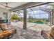 Screened-in pool area with outdoor seating, a peaceful pond view, and stylish patio pavers at 523 Wildlife Gln, Bradenton, FL 34209