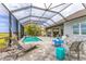 Relaxing screened-in pool area with a beautiful waterfront view and comfortable lounge seating at 523 Wildlife Gln, Bradenton, FL 34209