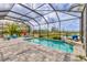 The screened-in pool area showcases a tranquil waterfront view, perfect for relaxation and entertainment at 523 Wildlife Gln, Bradenton, FL 34209