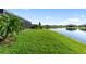 Picturesque backyard with a lush green lawn, serene lake views, and charming landscaping, perfect for outdoor enjoyment at 5333 Coral Reef Way, Bradenton, FL 34211