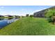 Spacious backyard with lush grass lawn and calming water view with abundant space for outdoor activities at 5333 Coral Reef Way, Bradenton, FL 34211