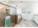 Bathroom featuring a glass enclosed shower, soaking tub, tile flooring and modern fixtures at 5333 Coral Reef Way, Bradenton, FL 34211