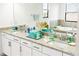 Bright bathroom featuring double vanity with granite countertop and decorative accents at 5333 Coral Reef Way, Bradenton, FL 34211