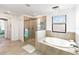 Bright bathroom featuring walk-in shower, soaking tub, and decorative chandelier at 5333 Coral Reef Way, Bradenton, FL 34211